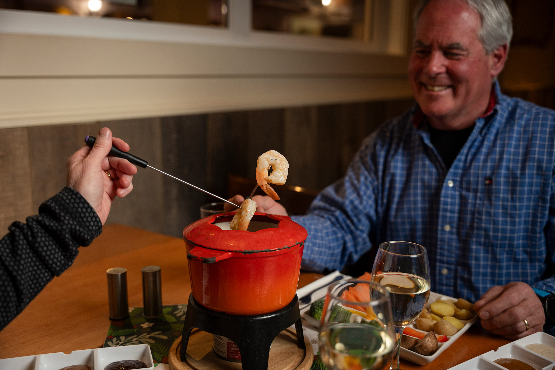 A couple eating fish fondue
