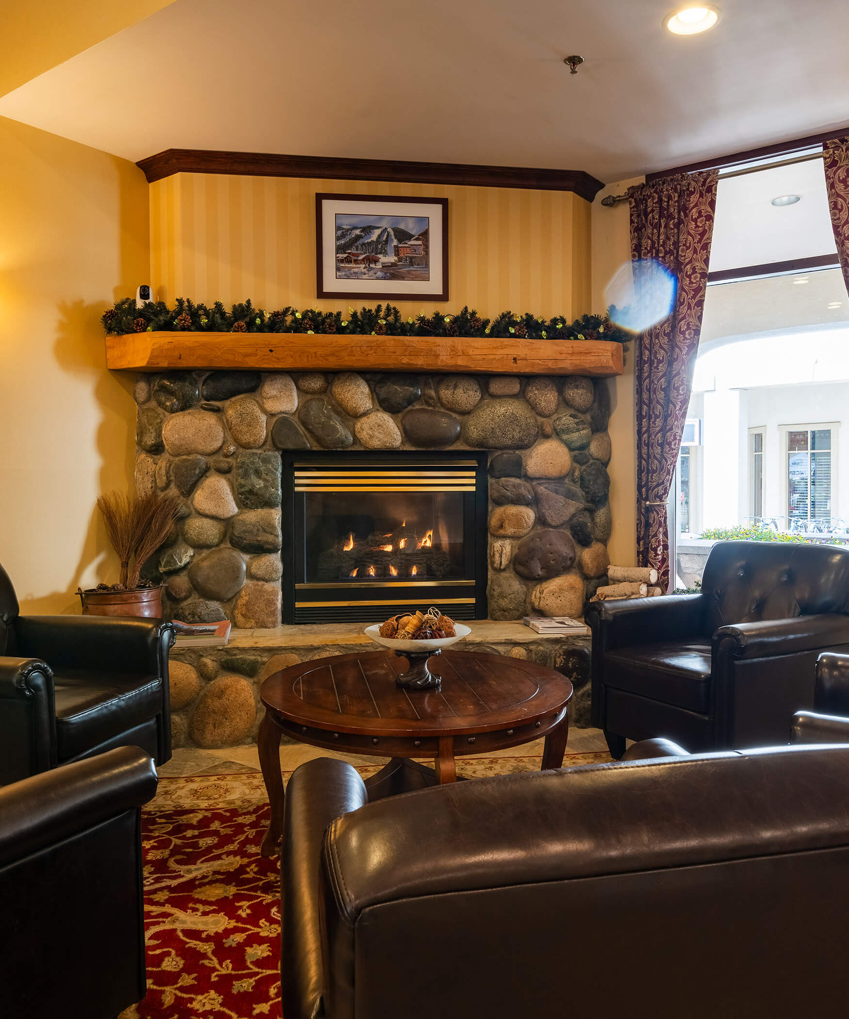 Fireplace with armchairs in the Sun Peaks Lodge